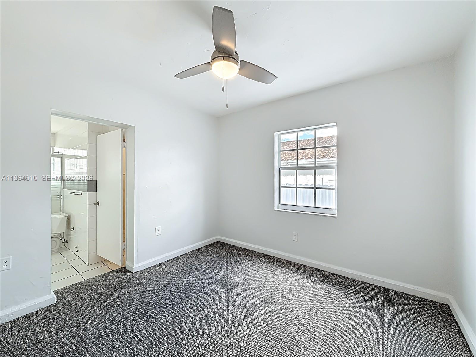 6819 Southwest 25th Street Miami, FL 33155 - Photo 10 of 25 an empty room with a window