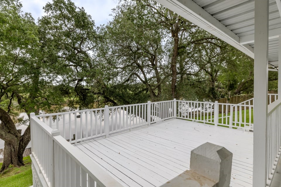 483 Riverside Drive Palacios, TX 77465 - Photo 35 of 41 a view of a wooden deck and a backyard