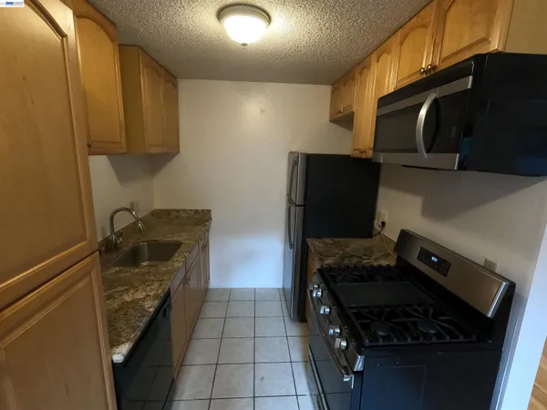 a kitchen with wooden cabinets and a stove top oven