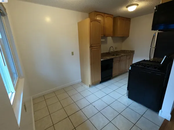 a kitchen with a refrigerator and a stove