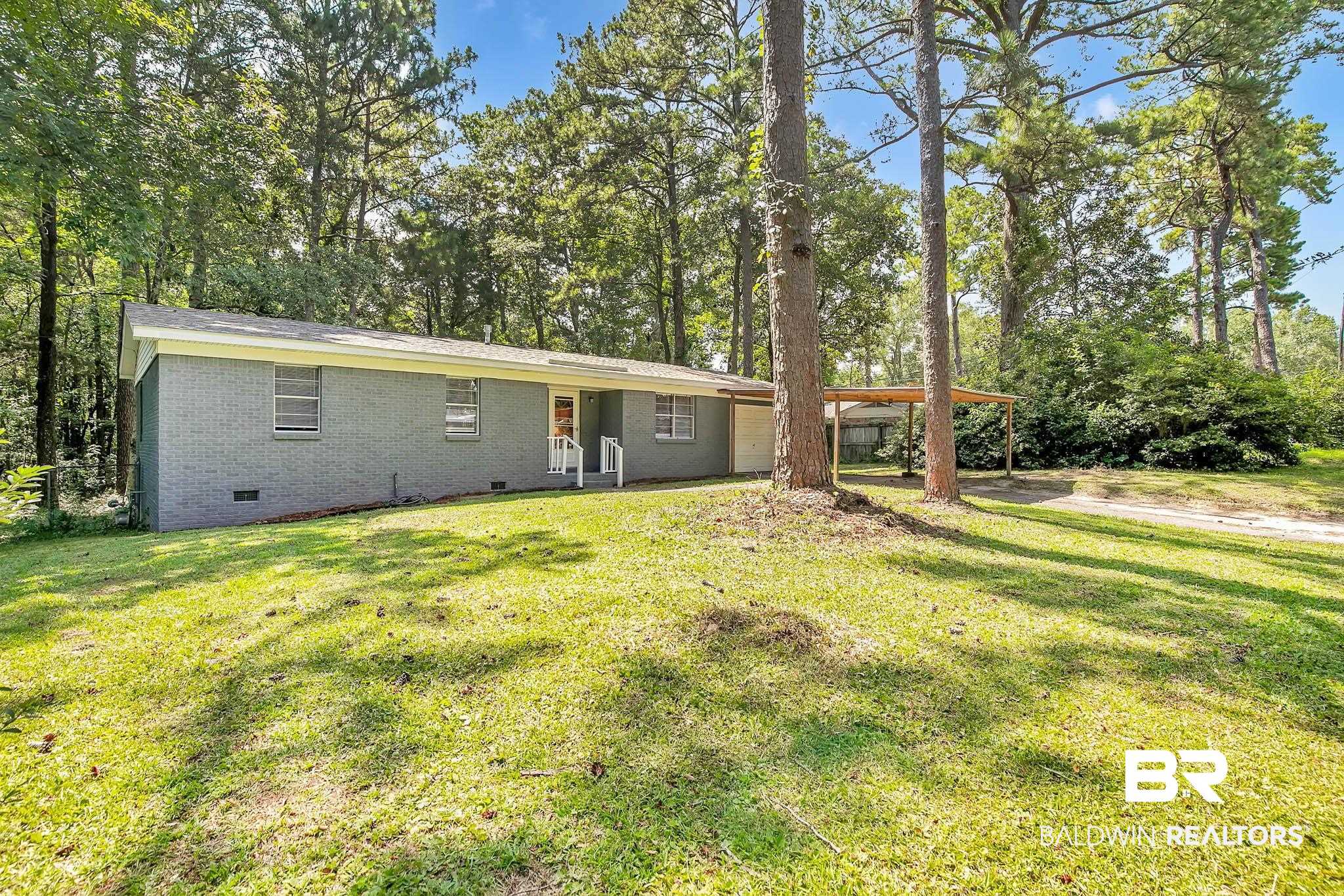 3304 Armond Drive Mobile, AL 36605 - Photo 59 of 62 Rear view of house with crawl space, a lawn, brick siding, and a carport