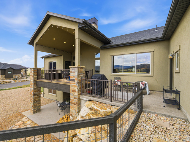 402 Shadow Hill Road Wanship, UT 84017 - Photo 72 of 90 Back of property with stucco siding, a patio area, a chimney, and roof with shingles