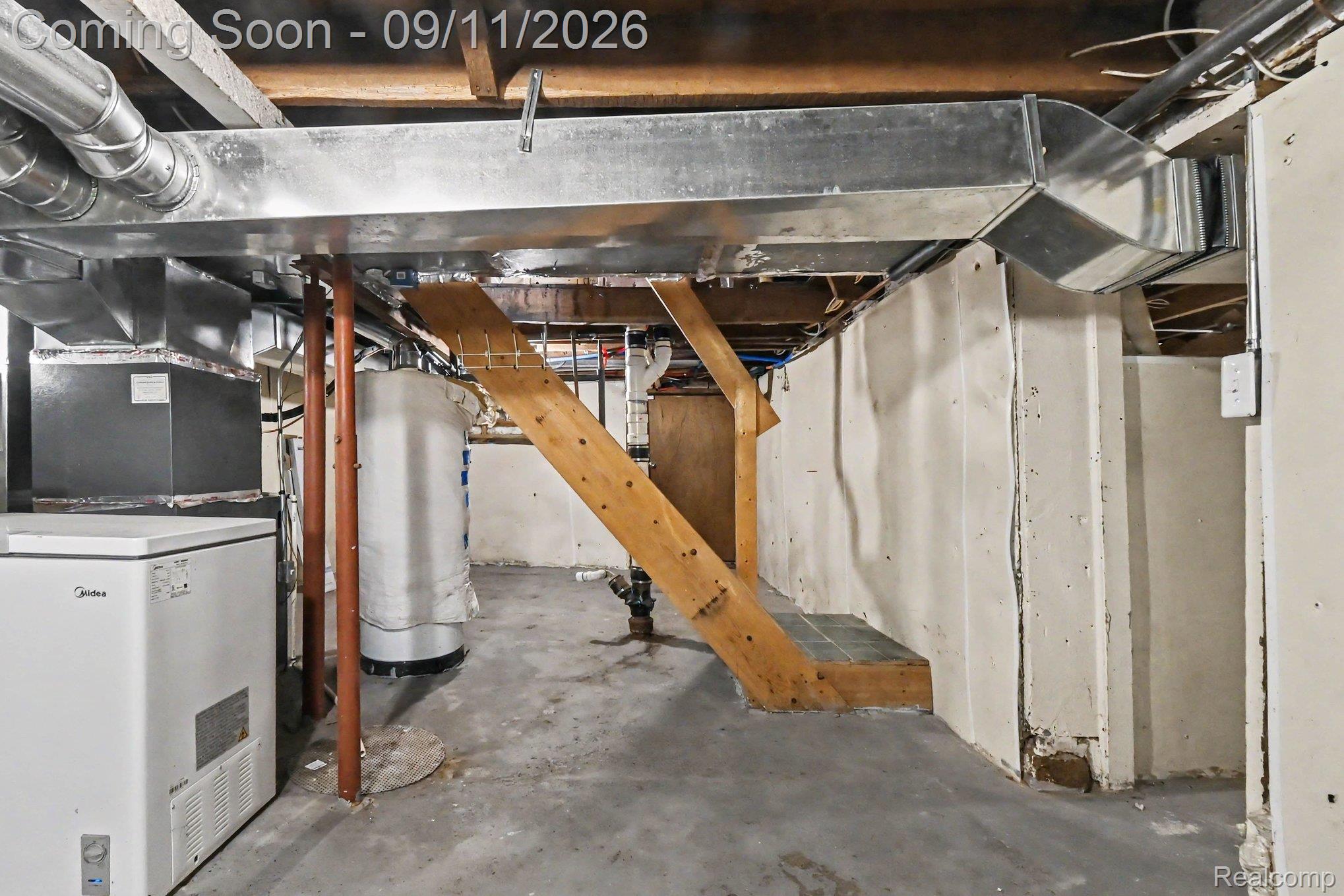 409 Fleming Street Howell, MI 48843 - Photo 21 of 25 Unfinished basement featuring exposed ductwork, concrete flooring, and a water heater