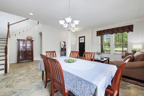 a view of a dining room with furniture window and outside view