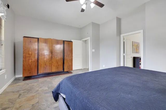 a view of a livingroom with a ceiling fan and window