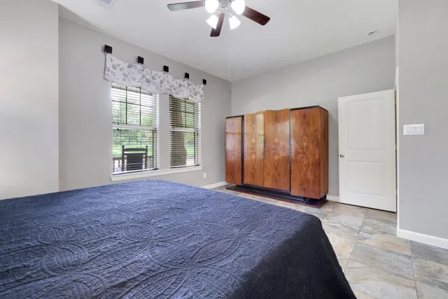 a view of an empty room with window and cabinet