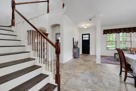 a view of entryway and hall with wooden floor