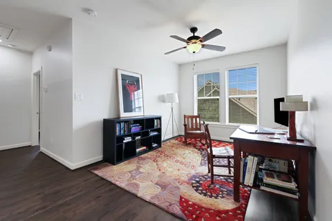 a living room with furniture and wooden floor