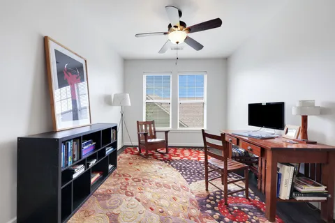 a view of a livingroom with workspace and a window