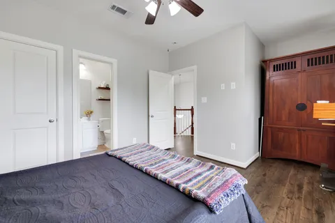 a spacious bedroom with a bed and a chandelier