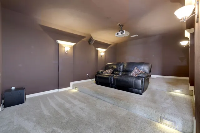 a living room with furniture a ceiling fan and a rug