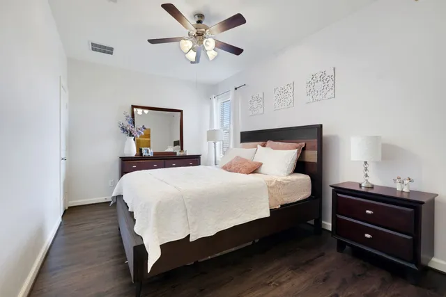 a bedroom with a bed and a chandelier