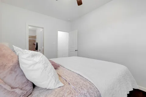 a bedroom with a bed and a chair