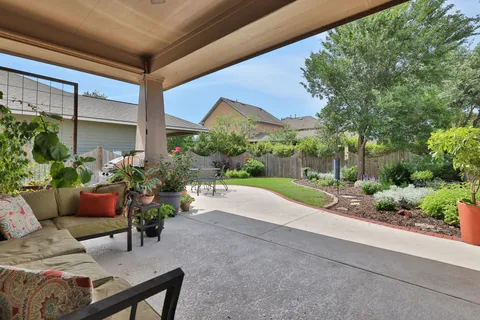 a view of a patio with couches and potted plants
