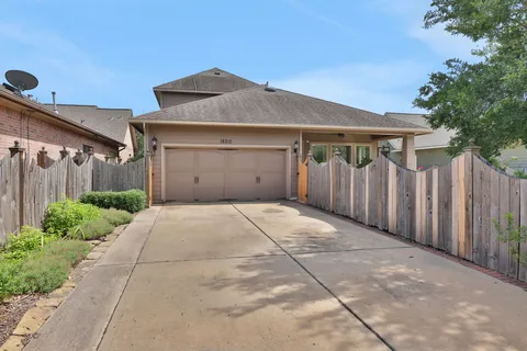 a front view of a house with a garage and a yard