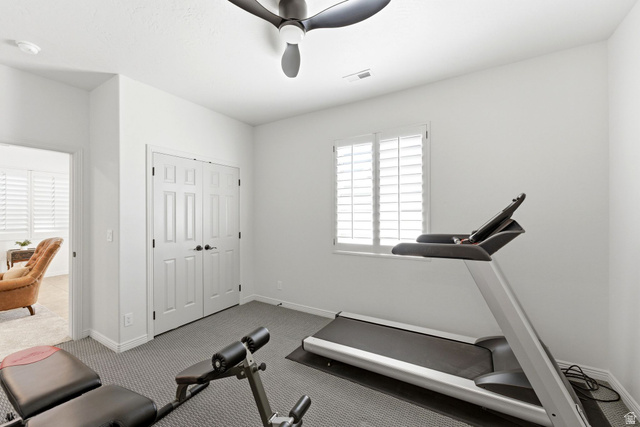1712 Somerset Ridge Drive Draper, UT 84020 - Photo 65 of 76 Room featuring a multi-panel window with plantation shutters, a ceiling fan, and double panel doors with dark hardware