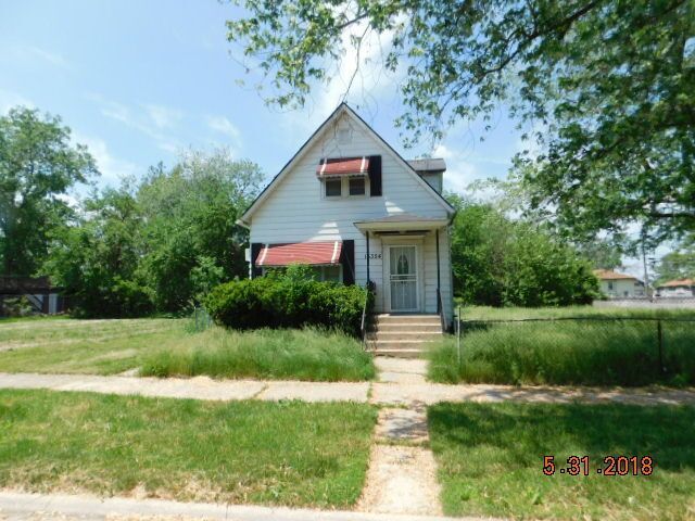 15354 5th Avenue Phoenix, IL 60426 - Photo 1 of 1 a front view of a house with a yard