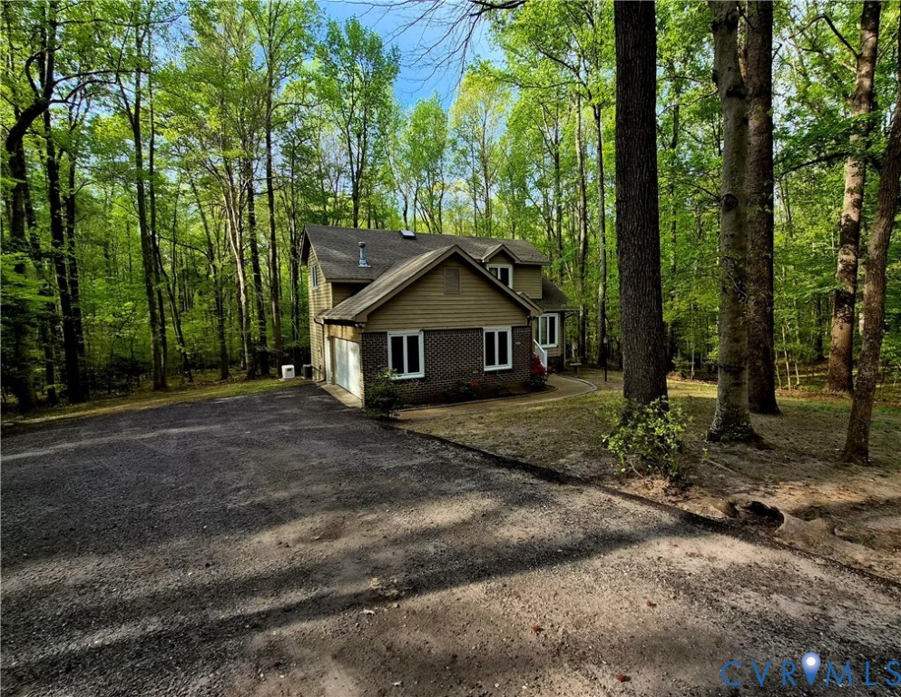 4099 Doe Run Road Hopewell, VA 23860 - Photo 5 of 35 a front view of a house with a yard and large tree