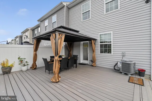a view of a patio with table and chairs and potted plants