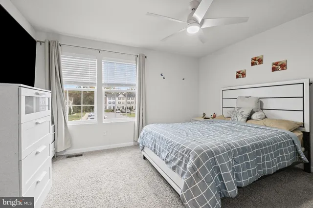a view of patio with table and chairs and potted plants
