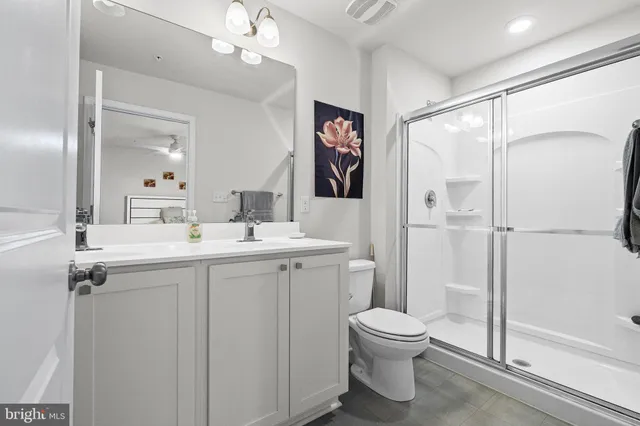 a bedroom with a large bed and a flat tv screen on dresser
