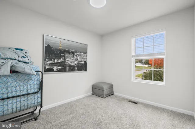 a bedroom with a flat screen tv and a window