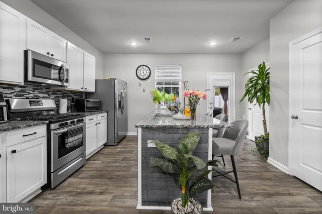 a living room with furniture kitchen view and a dining table