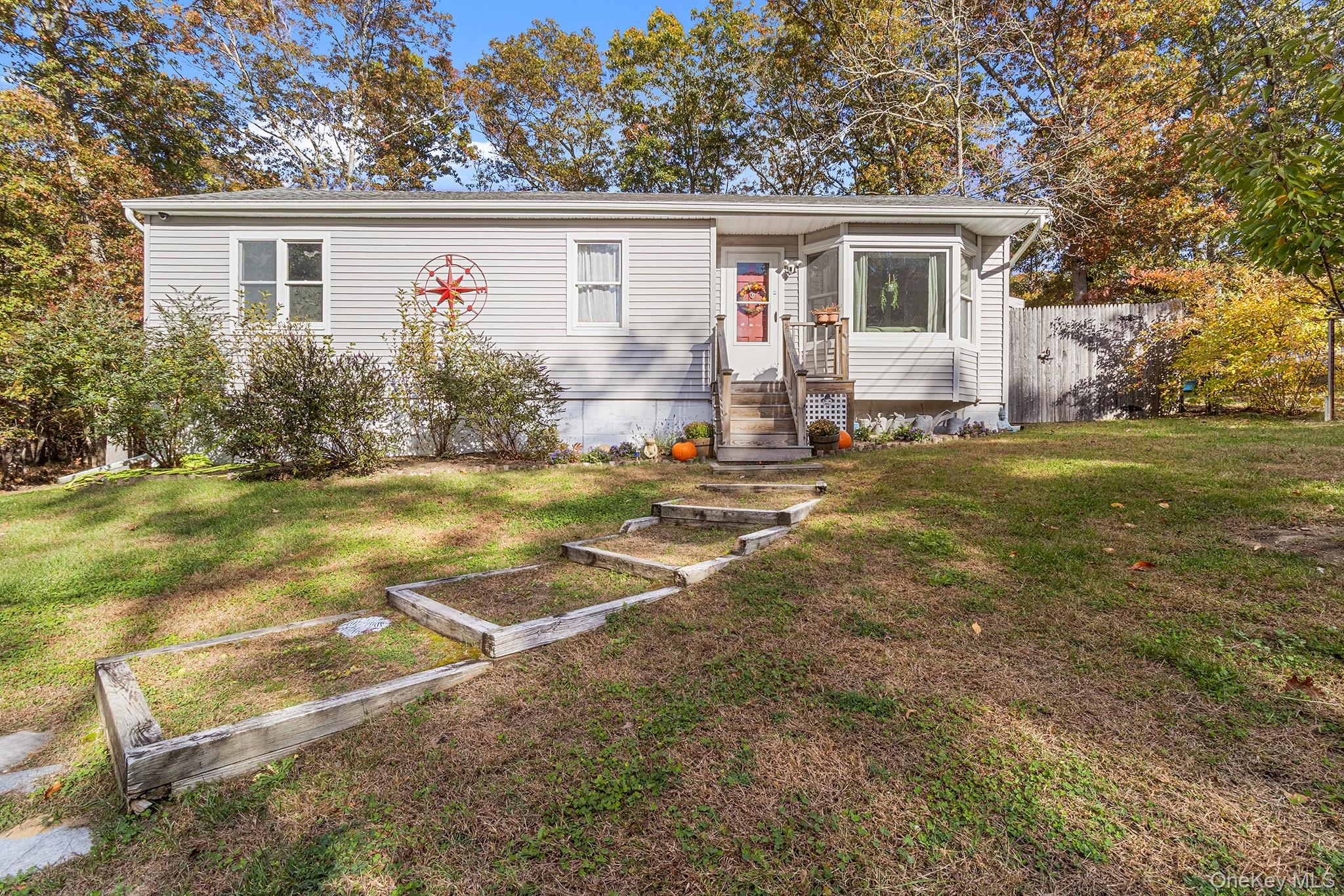 a view of backyard of house with green space