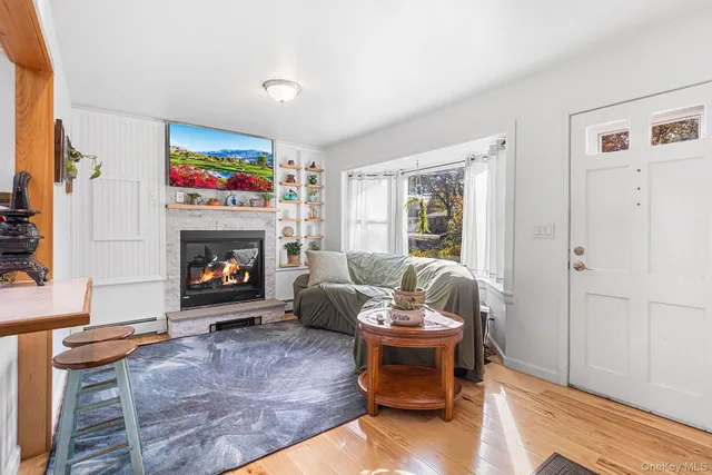 a living room with furniture a window and a fireplace