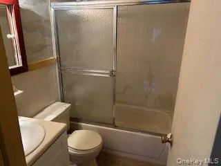 a white toilet sitting next to a bath tub