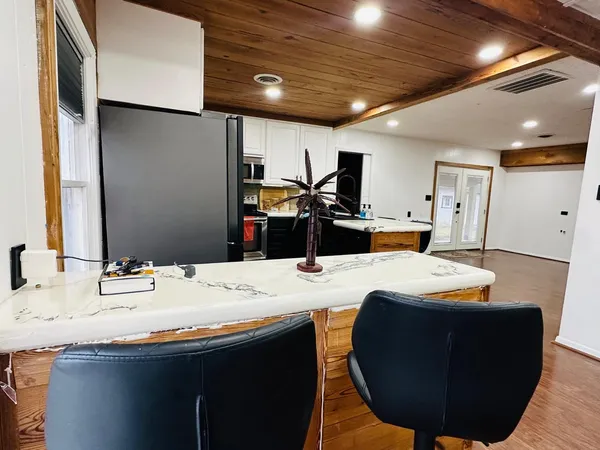a kitchen with a sink cabinets and wooden floor
