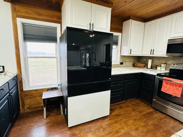a kitchen with stainless steel appliances a stove and a microwave