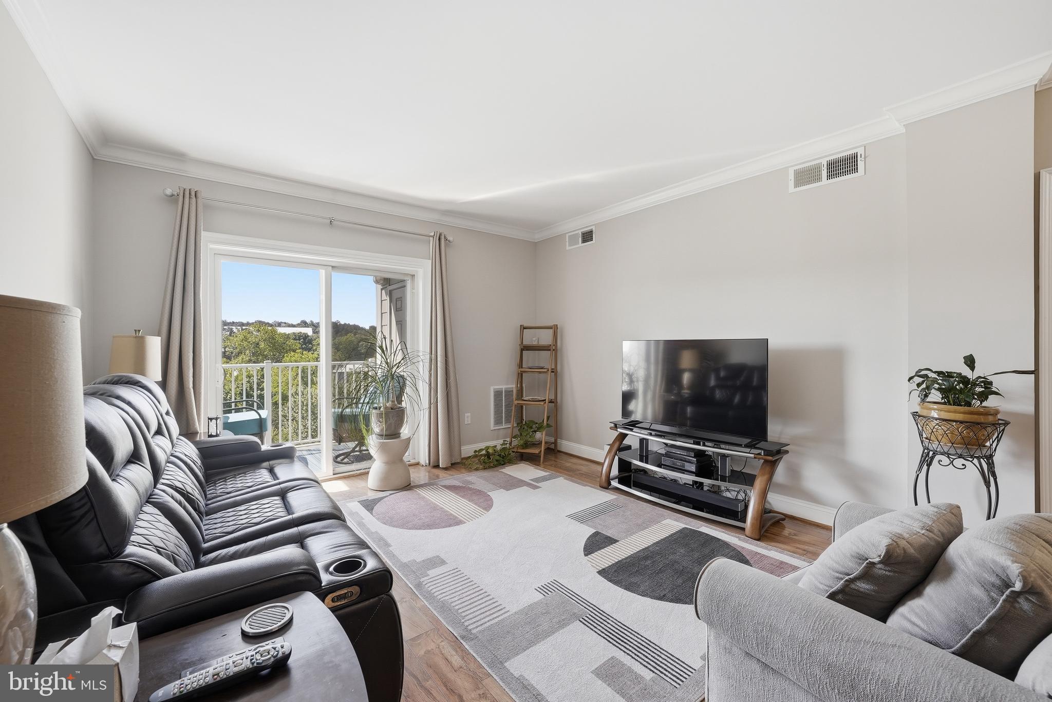 6301 Edsall Road, Unit 519 Alexandria, VA 22312 - Photo 11 of 33 a living room with furniture a flat screen tv and a large window