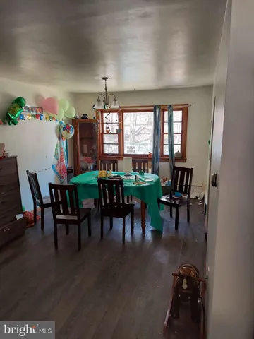 a dining room with furniture window and wooden floor