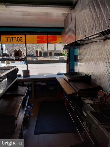 a kitchen with stainless steel appliances a sink stove and cabinets