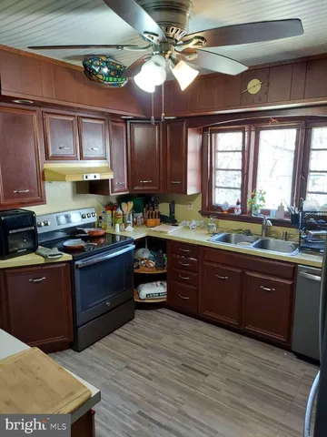 a kitchen with wooden cabinets and a sink