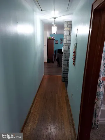 a view of hallway with wooden floor
