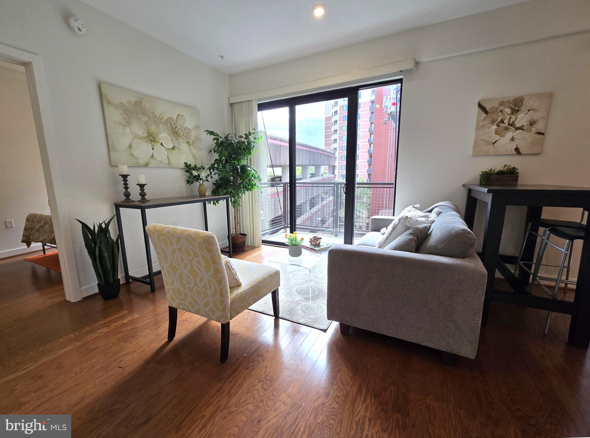 1320 Fenwick Lane, Unit 508 Silver Spring, MD 20910 - Photo 11 of 47 a living room with furniture and wooden floor
