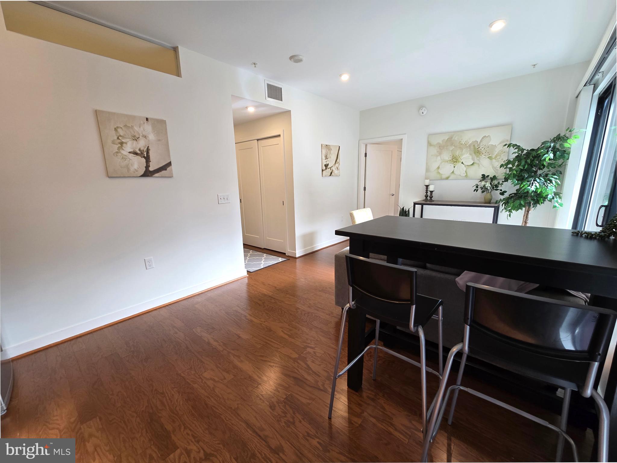 1320 Fenwick Lane, Unit 508 Silver Spring, MD 20910 - Photo 12 of 47 a room with wooden floor and furniture