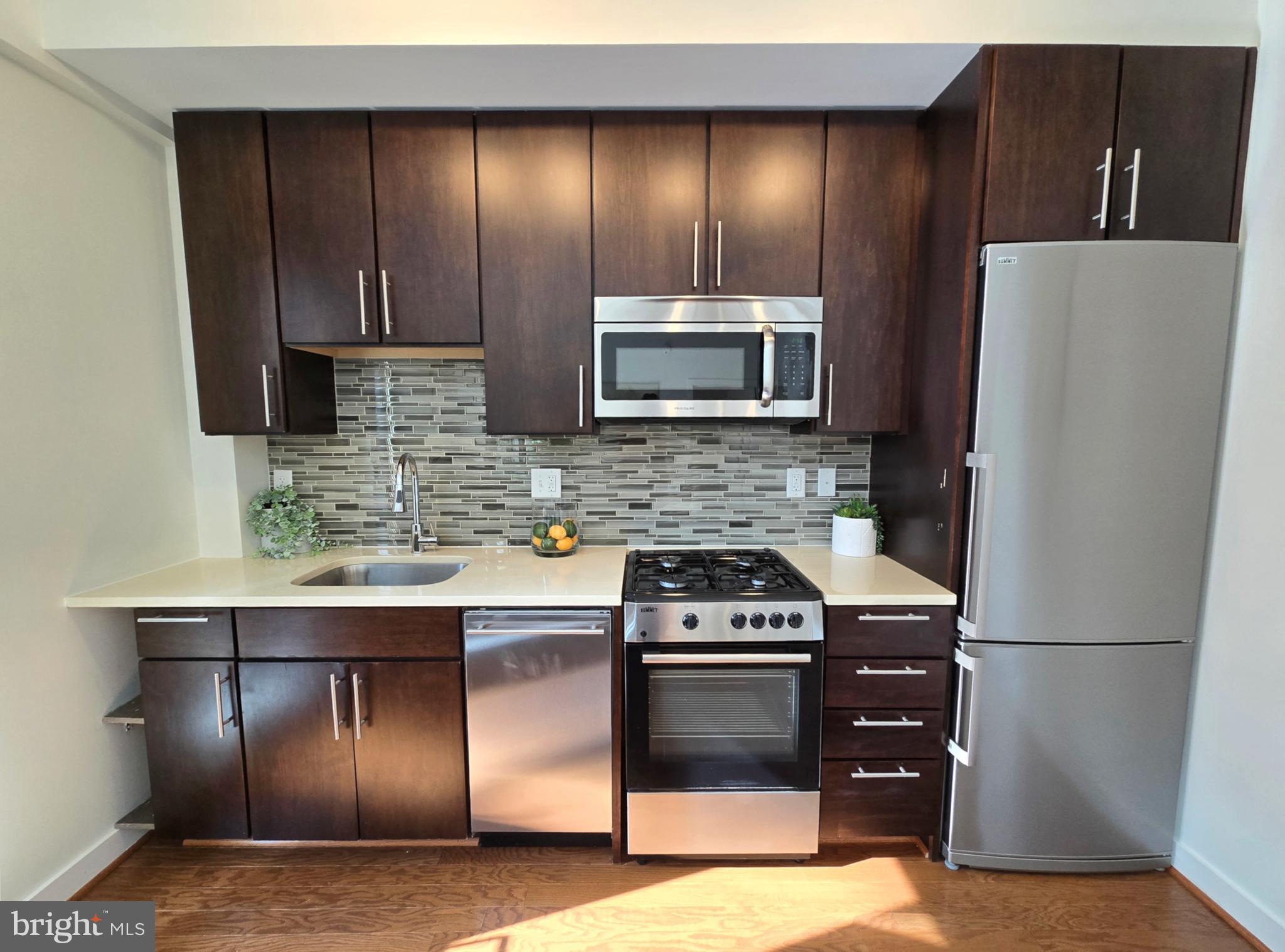 1320 Fenwick Lane, Unit 508 Silver Spring, MD 20910 - Photo 13 of 47 a kitchen with a refrigerator stove and microwave