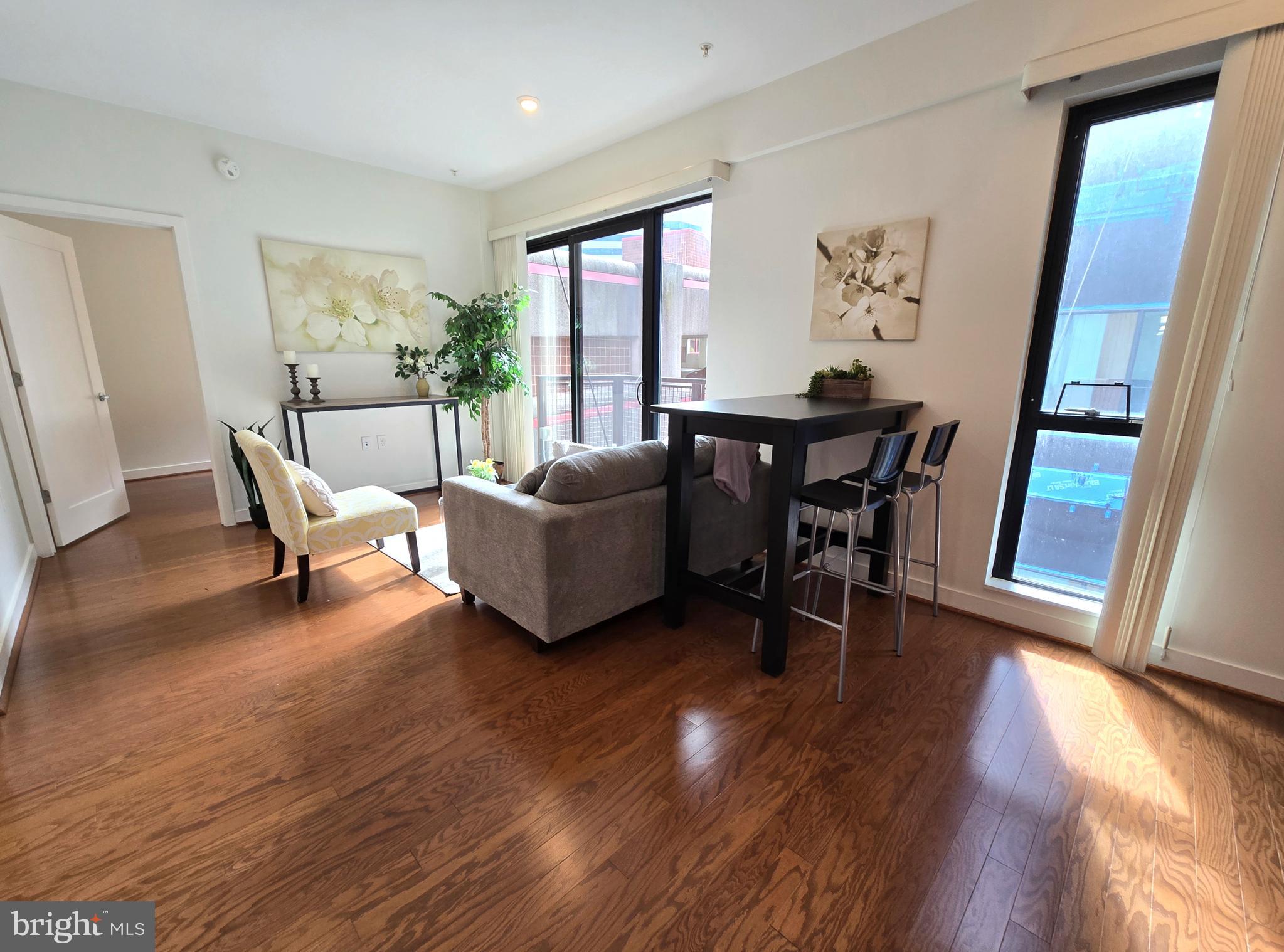 1320 Fenwick Lane, Unit 508 Silver Spring, MD 20910 - Photo 14 of 47 a living room with furniture and a wooden floor