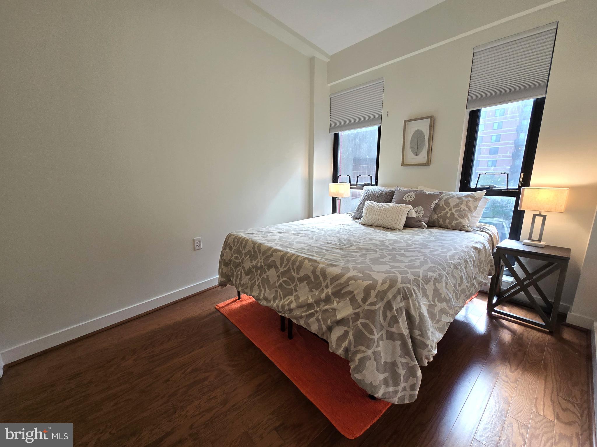 1320 Fenwick Lane, Unit 508 Silver Spring, MD 20910 - Photo 15 of 47 a bedroom with a bed and wooden floor