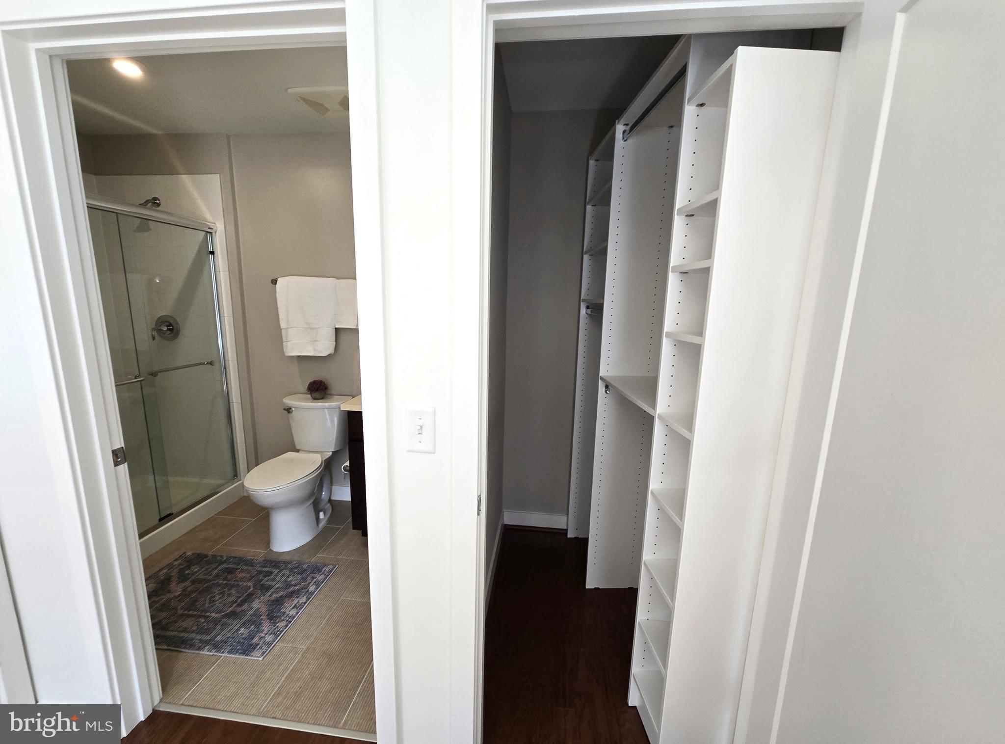 1320 Fenwick Lane, Unit 508 Silver Spring, MD 20910 - Photo 17 of 47 a bathroom with a granite countertop toilet and a shower