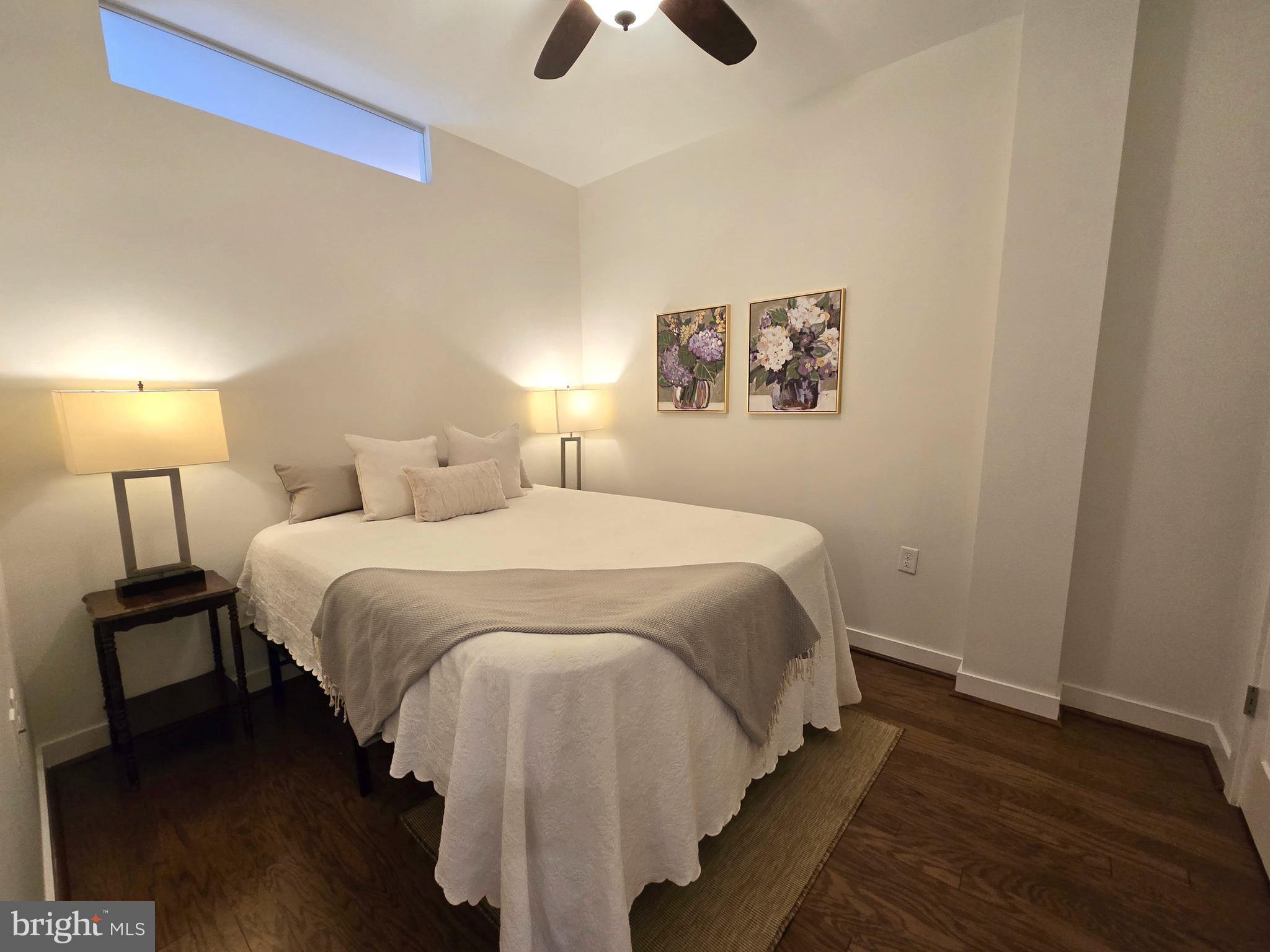 1320 Fenwick Lane, Unit 508 Silver Spring, MD 20910 - Photo 21 of 47 a bedroom with a bed and a chandelier