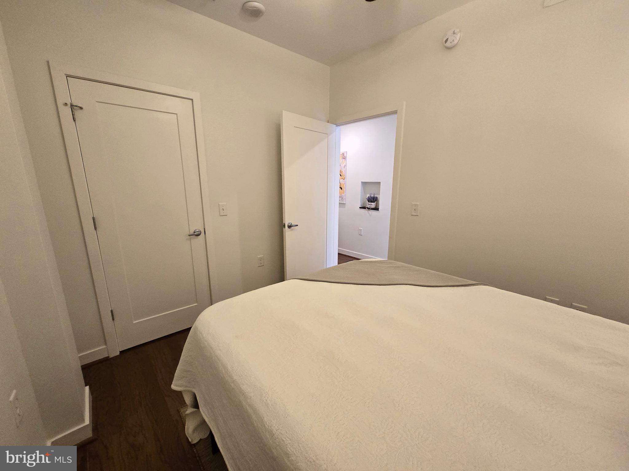 1320 Fenwick Lane, Unit 508 Silver Spring, MD 20910 - Photo 22 of 47 a bedroom with a bed and a mirror