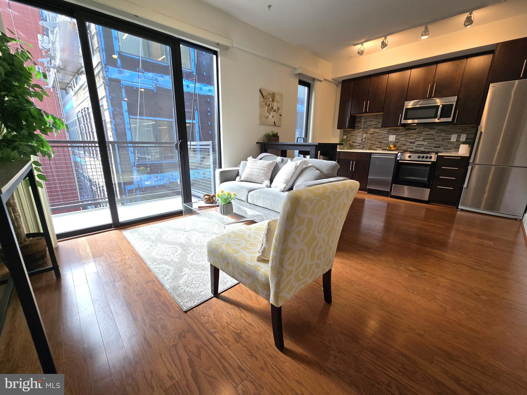 1320 Fenwick Lane, Unit 508 Silver Spring, MD 20910 - Photo 5 of 47 a living room with furniture and a flat screen tv