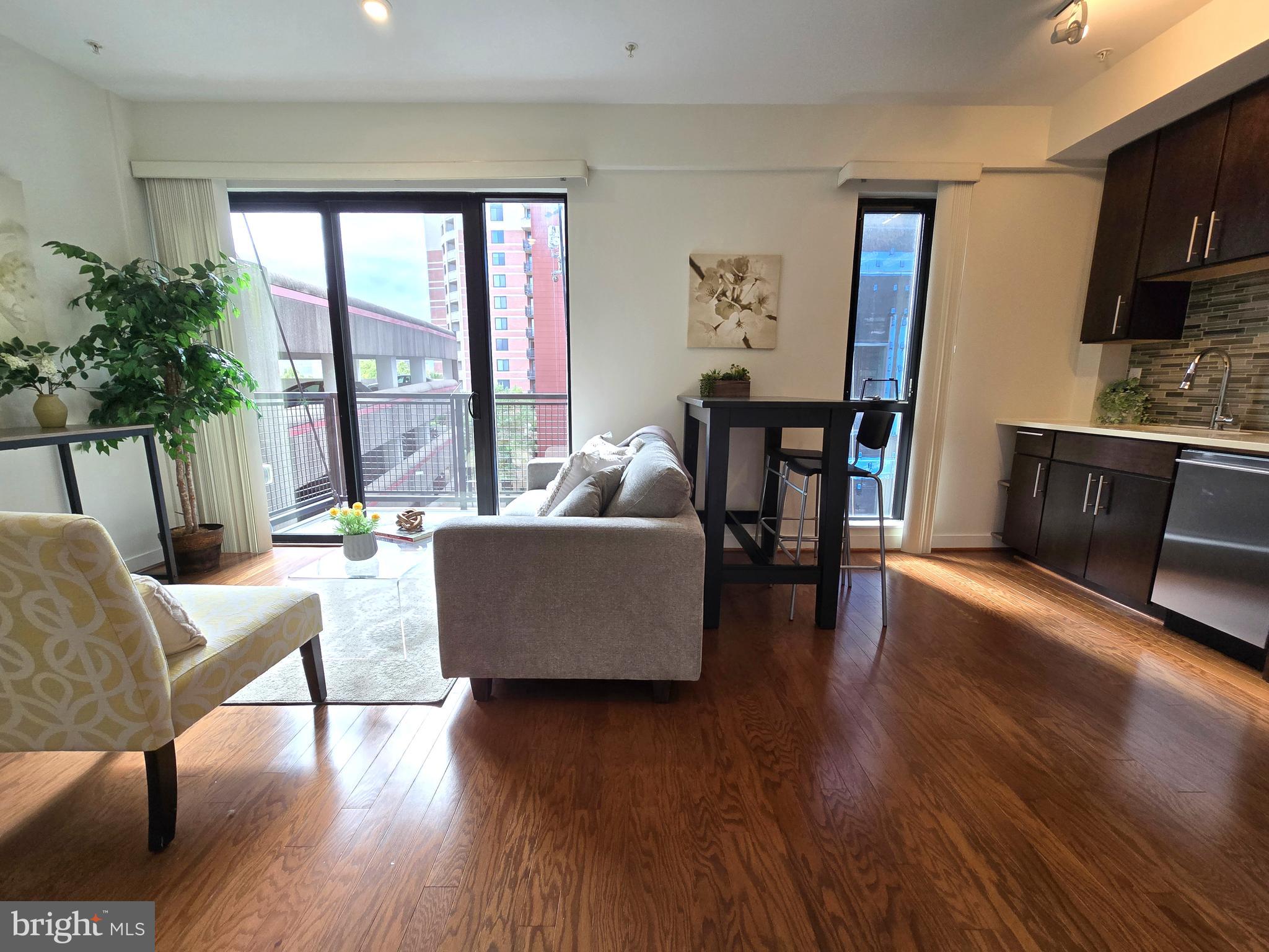 1320 Fenwick Lane, Unit 508 Silver Spring, MD 20910 - Photo 6 of 47 a living room with furniture and a large window