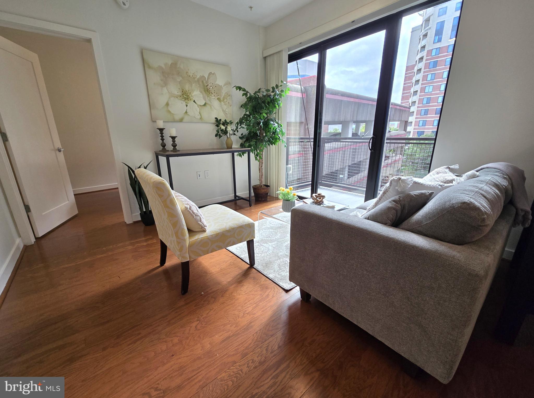 1320 Fenwick Lane, Unit 508 Silver Spring, MD 20910 - Photo 7 of 47 a living room with furniture and a large window