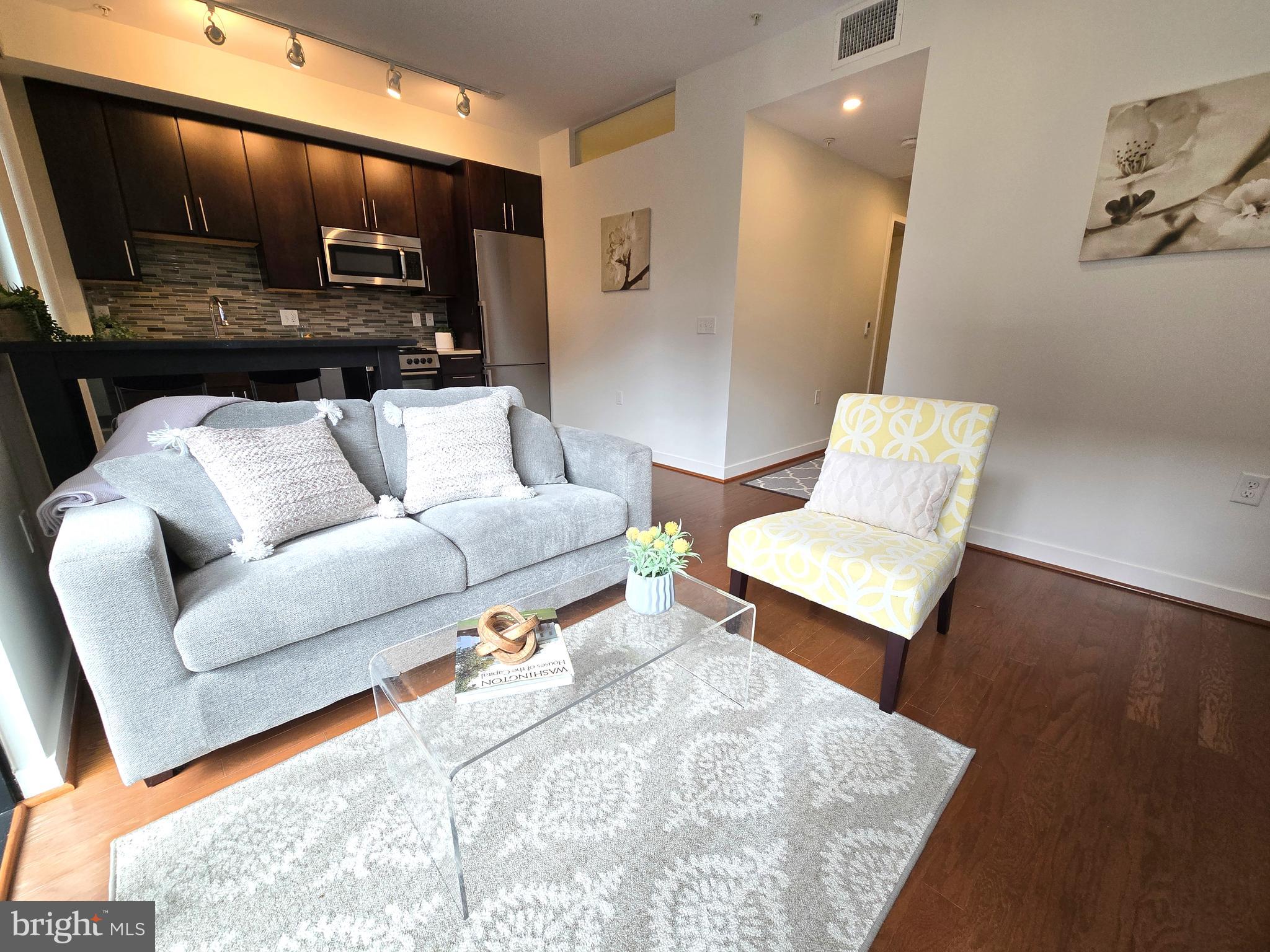 1320 Fenwick Lane, Unit 508 Silver Spring, MD 20910 - Photo 10 of 47 a living room with furniture and a flat screen tv