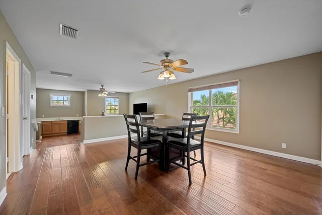 a view of a dining room with furniture and wooden floor